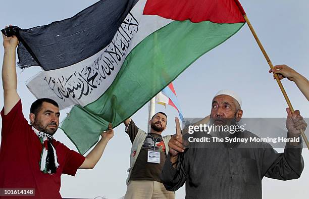 Negati Akar Recap Goker from Turkey, and Ismail Ali wave the Palestinian flag onboard the Turkish passenger ship Mavi Marmara as it heads to Gaza as...