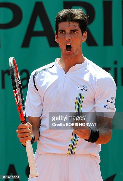 Brazil's Thomaz Bellucci reacts after he defeated Spain's Pablo Andujar at the end of their second round match in the French Open tennis championship...