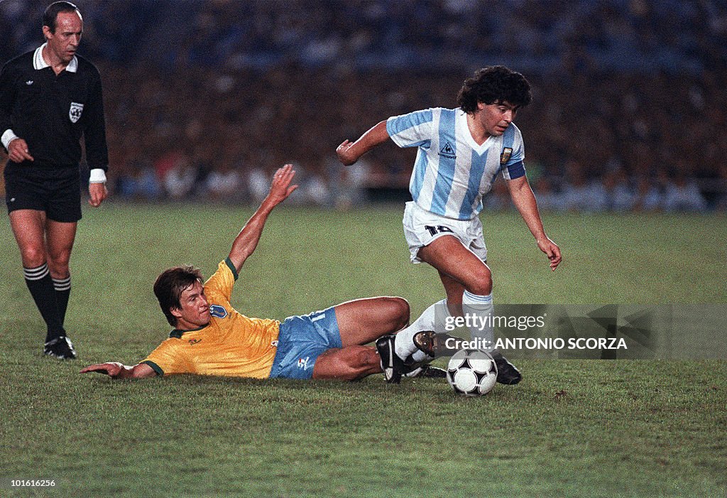 Argentina's Diego Maradona (R) slips pas