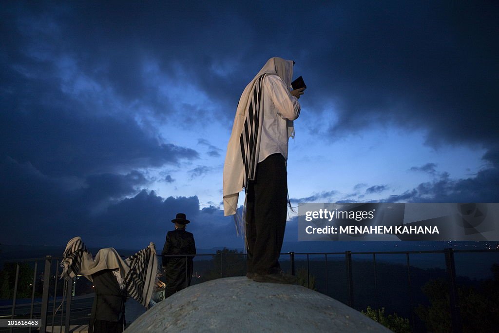 Ultra Orthodox Jews pray at the grave si