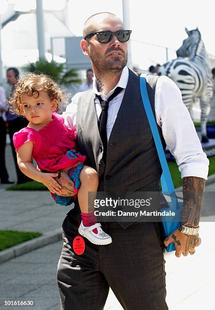 Shane Lynch from Boyzone and child attend the Investec Ladies Day at Epsom Downs on June 4, 2010 in Epsom, England.