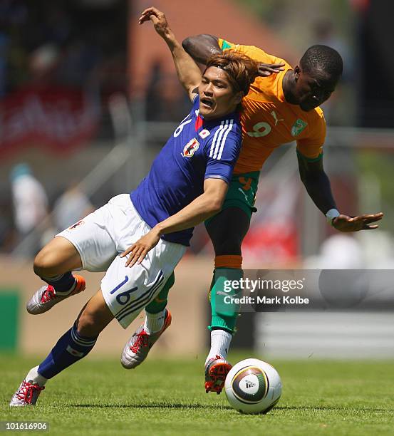 Shinji Okazaki of Japan competes for the ball against Ismael Tiote of Ivory Coast during the Japan v Ivory Coast International Friendly match at...