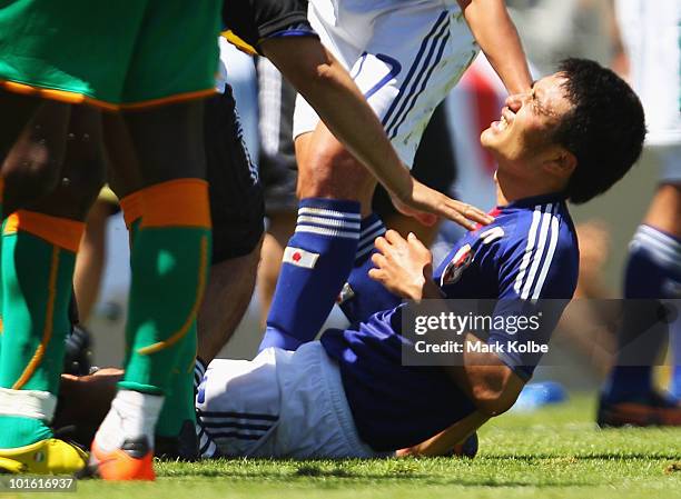 Yasuyuki Konno of Japan is injured during the Japan v Ivory Coast International Friendly match at Stade de Toubillon on June 4, 2010 in Sion,...