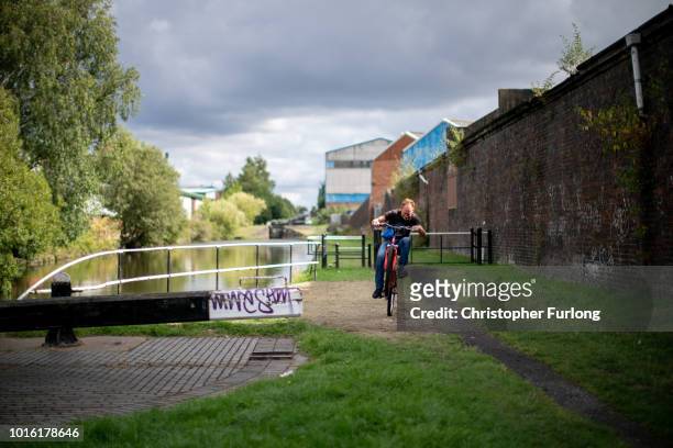 Man rides his bicycle next to the canal in Great Bridge, in the Black Country, which was among the 29 out of 30 West Midlands voting areas to back...