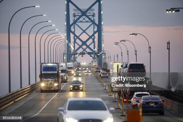 Commercial trucks and passenger vehicles drive across Ambassador Bridge on the Canada-U.S. Border in Windsor, Ontario, Canada, on Thursday, Aug. 9,...
