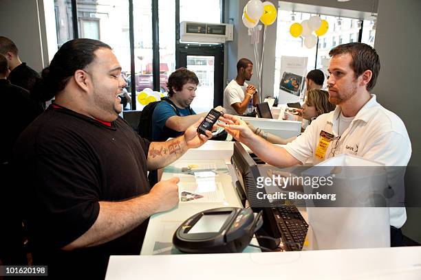 Joshua Carrero, left, is the first customer to purchase the HTC Corp. 4G Evo phone, which is powered by Google Inc.'s Android software, from...