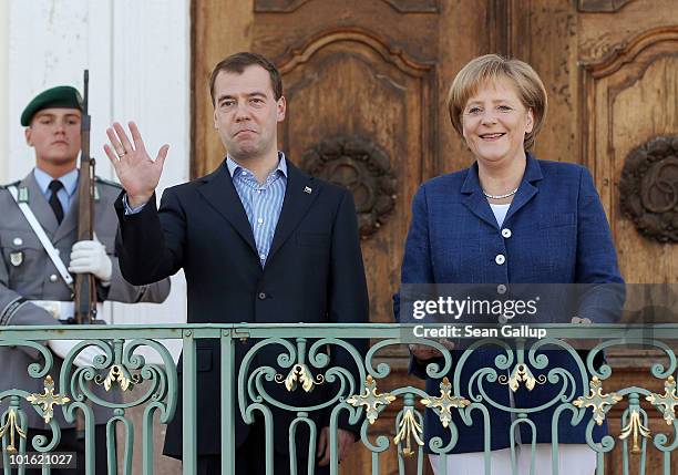 German Chancellor Angela Merkel and Russian President Dmitry Medvedev look to the media upon Medvedev's arrival at Meseberg Palace on June 4, 2010 in...