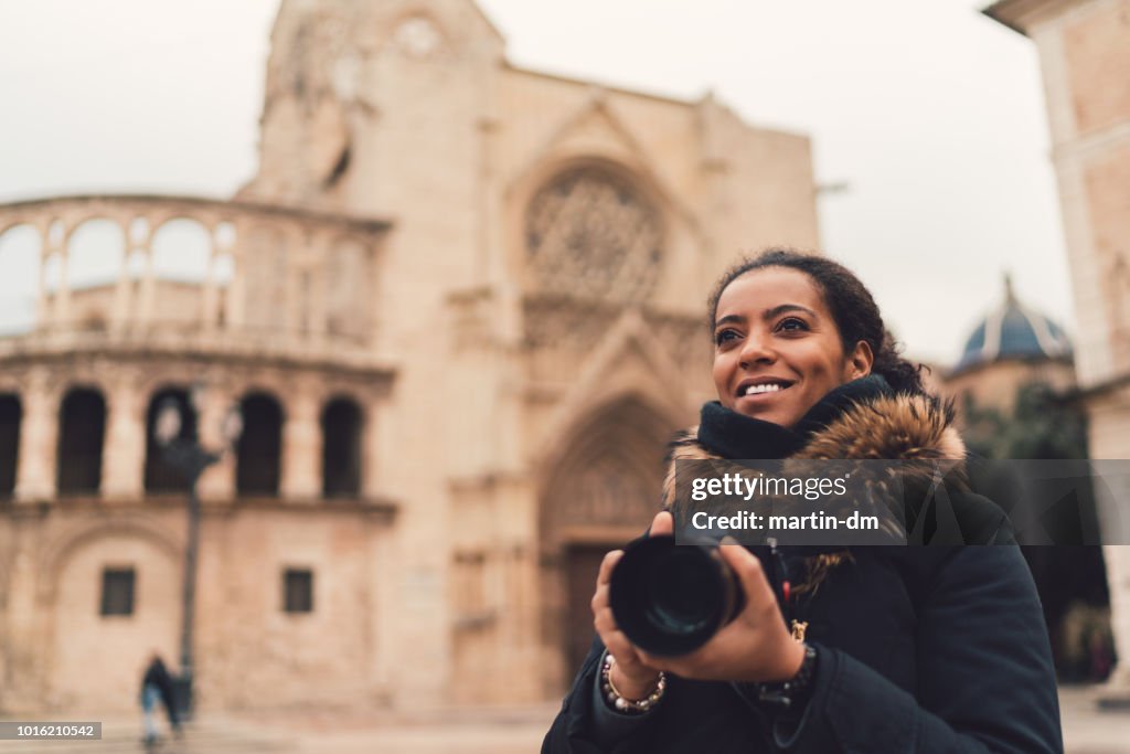 Mixed race woman traveling single in Europe,Plaza de la Virgen,Valencia