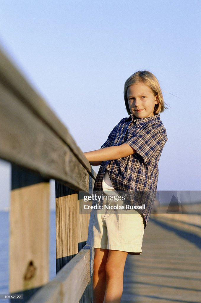 YOUNG GIRL PORTRAIT AT BAY ON PIER