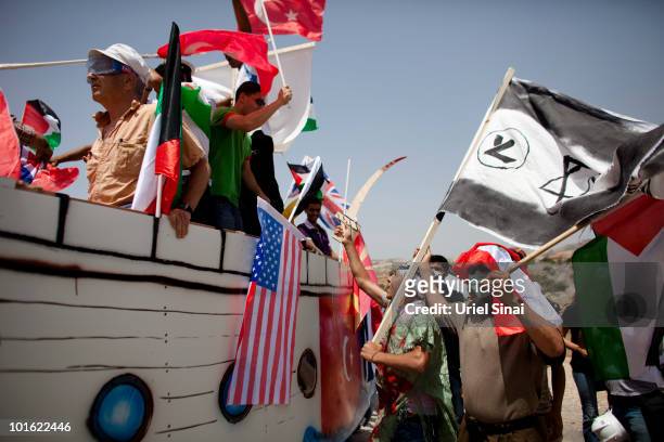 Palestinian protesters use a replica of a Gaza Aid flotilla vessel near an Israeli barrier, as they object to Israel's attack on the flotilla earlier...