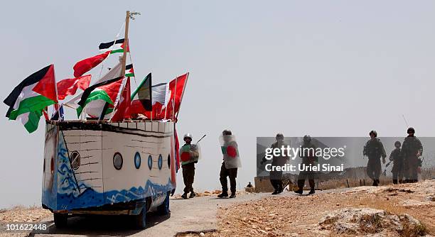 Israeli soldiers approach a replica of the Gaza aid flotilla used by Palestinians near an Israeli barrier, as they object to Israel's attack on the...