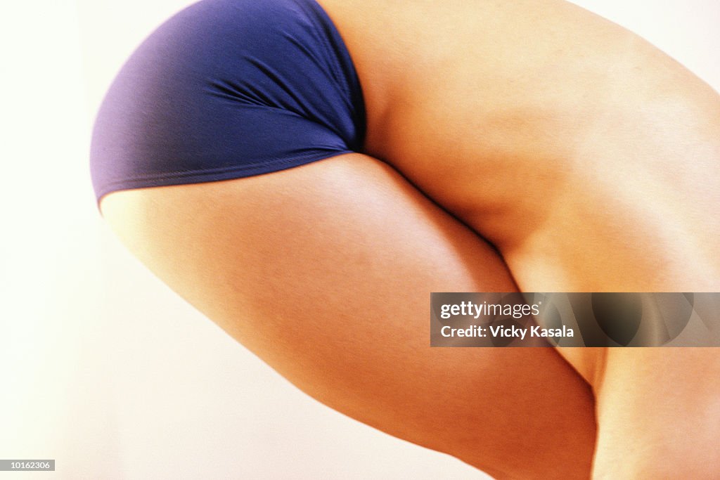 WOMAN STANDING IN FETAL POSITION