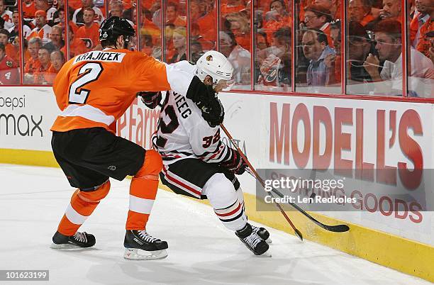 Lukas Krajicek of the Philadelphia Flyers battles for the puck against Kris Versteeg of the Chicago Blackhawks in Game Three of the 2010 NHL Stanley...