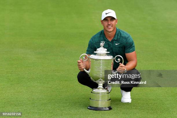 Brooks Koepka of the USA celebrates with the winners trophy on the 18th green after winning the 2018 PGA Championship at Bellerive Golf & Country...