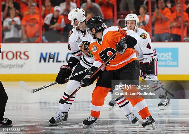 Danny Briere of the Philadelphia Flyers faces-off at the start of the first overtime period against Dave Bolland of the Chicago Blackhawks in Game...