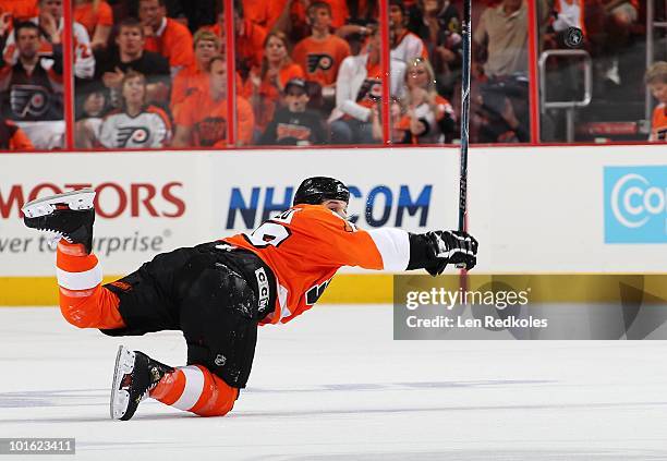 Dan Carcillo of the Philadelphia Flyers tries to flag down an air bourn puck against the Chicago Blackhawks in Game Three of the 2010 NHL Stanley Cup...