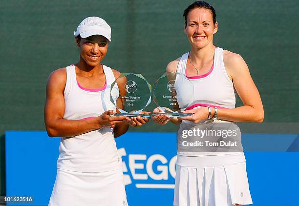 Sarah Borwell of Great Britain and Raquel Kops-Jones of the United States pose with the trophies after winning the women's doubles final match...