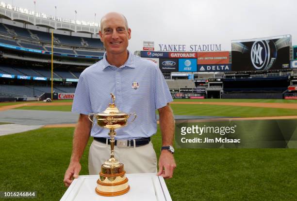 United States Ryder Cup Captain Jim Furyk poses for a photograph with the Ryder Cup trophy prior to a game between the New York Yankees and the New...