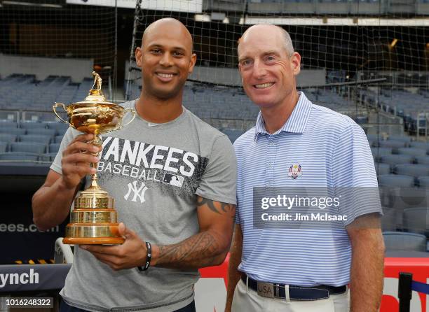 United States Ryder Cup Captain Jim Furyk poses for a photograph with Aaron Hicks of the New York Yankees prior to a game between the Yankees and the...