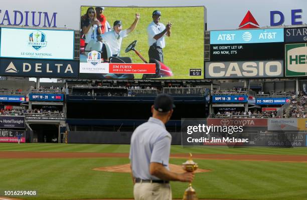 United States Ryder Cup Captain Jim Furyk watches a video presentation prior to throwing the ceremonial first pitch of a game between the New York...