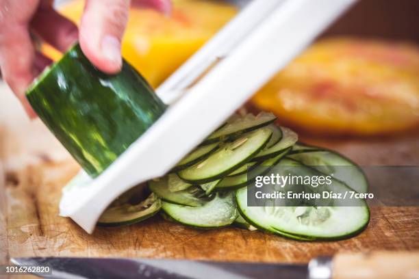 raw vegetable preparation, mandolin cucumber 1 - mandolina fotografías e imágenes de stock