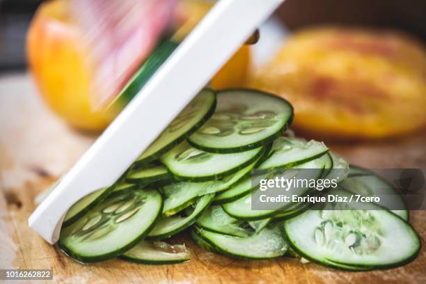 raw vegetable preparation, mandolin cucumber 3 - mandolino foto e immagini stock