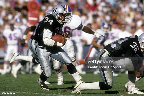 Running back Bo Jackson of the Los Angeles Raiders in action carries the ball against the Denver Broncos December 3, 1989 during an NFL game at the...