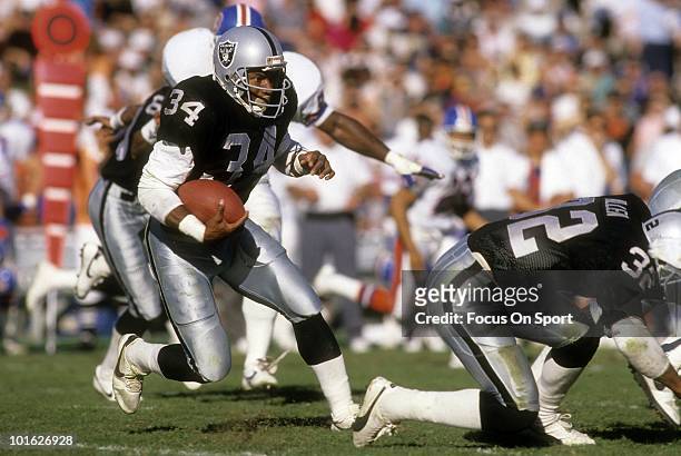 Running back Bo Jackson of the Los Angeles Raiders in action carries the ball against the Denver Broncos December 3, 1989 during an NFL game at the...