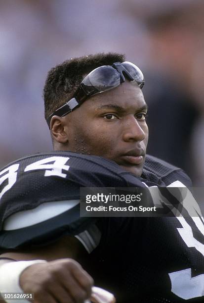 CiRCA 1990: Running back Bo Jackson of the Los Angeles Raiders in this portrait watching the action from the bench circa 1990 during an NFL game at...