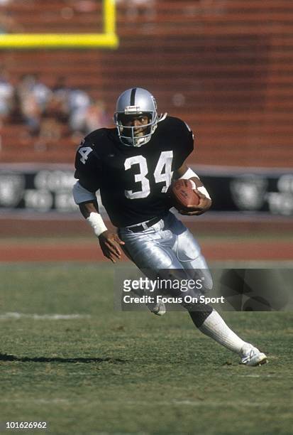 CiRCA 1990: Running back Bo Jackson of the Los Angeles Raiders in action carries the ball circa 1990 during an NFL game at the Los Angeles Coliseum...