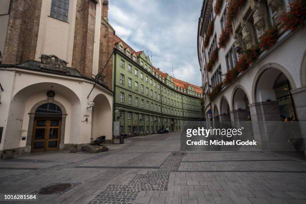 cobblestone street with residential buildings against cloudy sky, munich, germany - munich street stock pictures, royalty-free photos & images