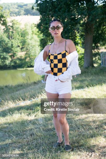 Model and Actress Betty Bachz wears Moy Atelier sunglasses, Solid and Striped jacket, swim suit and shorts, and Paloma Barcelo Espadrilles during...