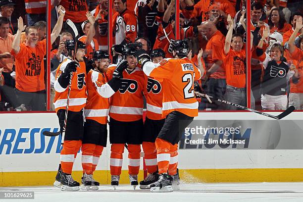 Matt Carle of the Philadelphia Flyers celebrates with teammates after scoring a goal in the first period against Antti Niemi of the Chicago...