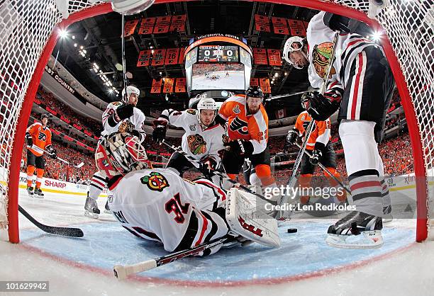 Ville Leino and Simon Gagne of the Philadelphia Flyers battle for the loose puck in the crease of goaltender Antti Niemi of the Chicago Blackhawks...