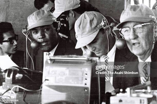 Olympic gold medalist in Decathlon in 1960 Rome Olympic, Rafer Johnson of the United States is in a commentator seat during the Tokyo Olympic Games...