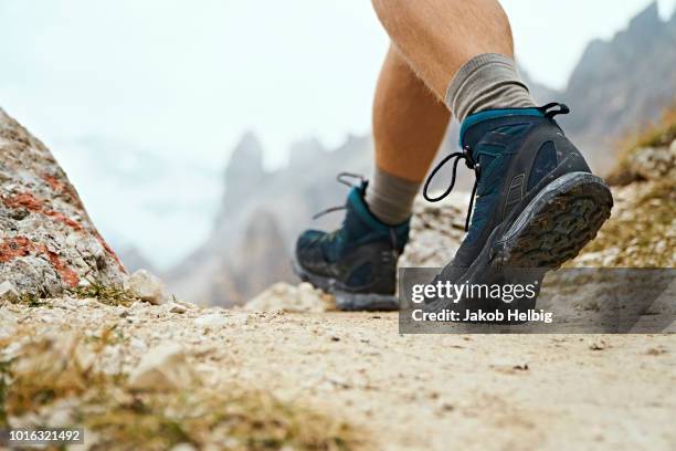 hiker on dirt track, canazei, trentino-alto adige, italy - hiking shoes stock-fotos und bilder