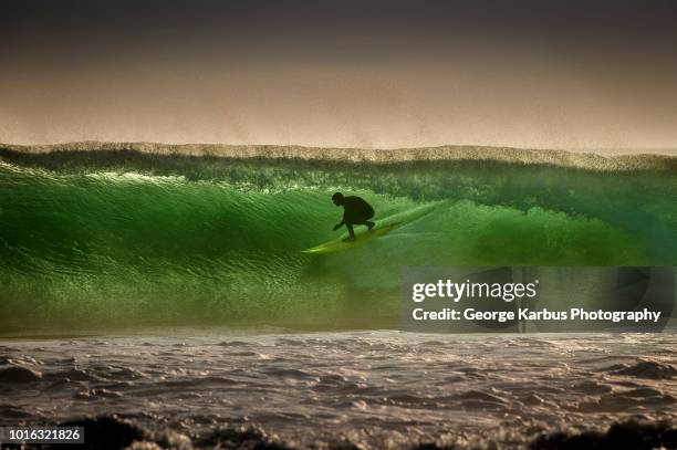 surfer surfing on barreling wave, crab island, doolin, clare, ireland - ireland surf wave ストックフォトと画像