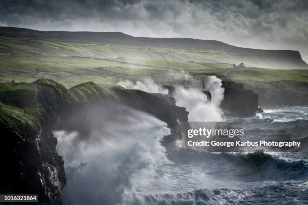 waves crashing against the cliffs of moher, doolin, clare, ireland - erodiert stock-fotos und bilder
