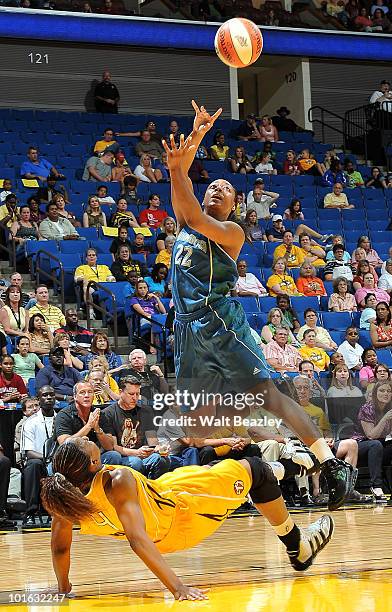 Amber Holt of the Tulsa Shock takes a charge against Monica Wright of the Minnesota Lynx at the Bok Center June 4, 2010 in Tulsa, Oklahoma. NOTE TO...