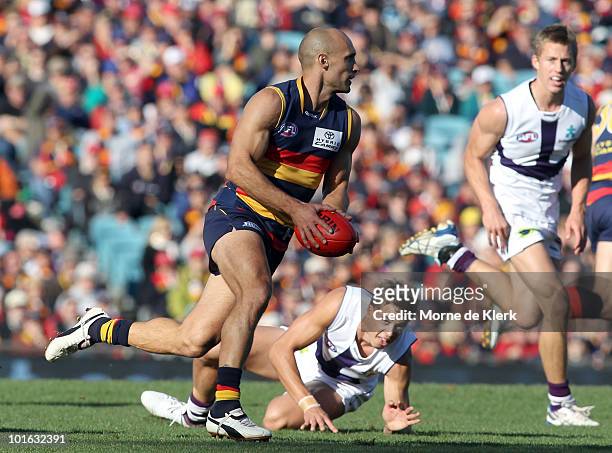 Tyson Edwards of the Crows runs with the ball during the round 11 AFL match between the Adelaide Crows and the Fremantle Dockers at AAMI Stadium on...