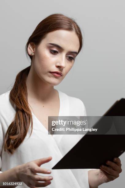 woman reading documents - v neck stock pictures, royalty-free photos & images
