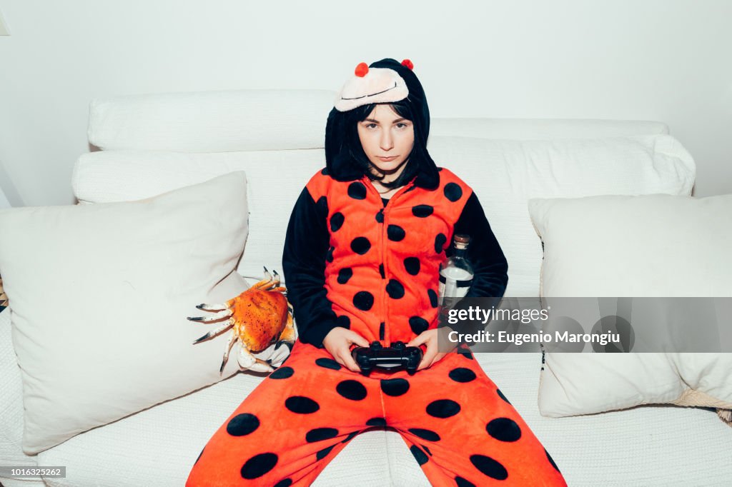 Woman wearing adult bodysuit holding games controller