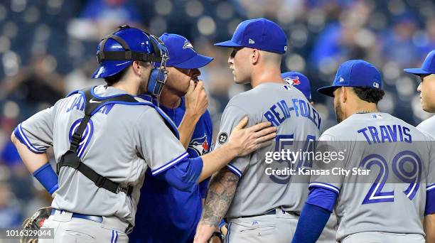 Toronto Blue Jays starting pitcher Sean Reid-Foley receives a visit to the mound from pitching coach Pete Walker in the fourth inning against the...