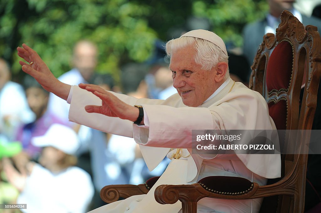 Pope Benedict XVI gestures to the crowd