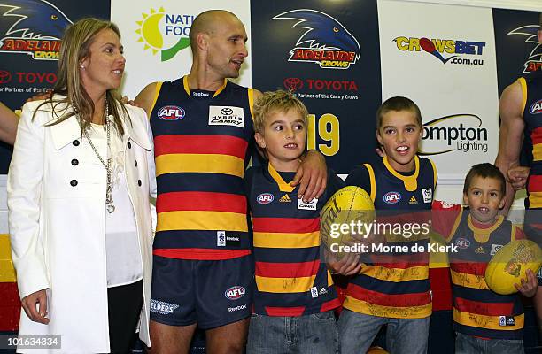 Tyson Edwards of the Crows celebrates in the changerooms after his last game with his wife Mandy and sons Luke Jackson and Brodie after the round 11...