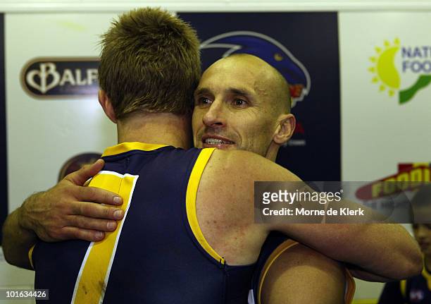 Tyson Edwards of the Crows hugs team mate Nathan Van Berlo after playing in his last AFL game after the round 11 AFL match between the Adelaide Crows...