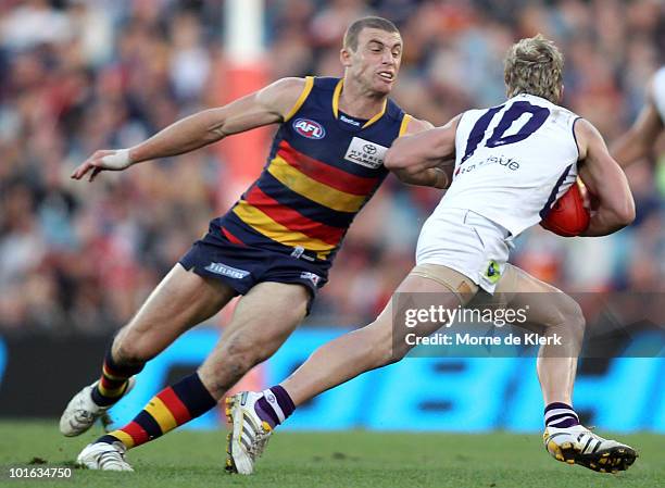 Simon Goodwin of the Crows tackles Rhys Palmer of the Dockers during the round 11 AFL match between the Adelaide Crows and the Fremantle Dockers at...