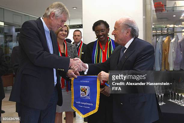 President Joseph S. Blatter hands-over a commemorative pennant to Bart Dorrestein , Chairman of Legacy Group during the opening of a new bridge...