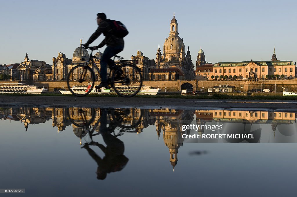 A cyclist rides along the the banks of t