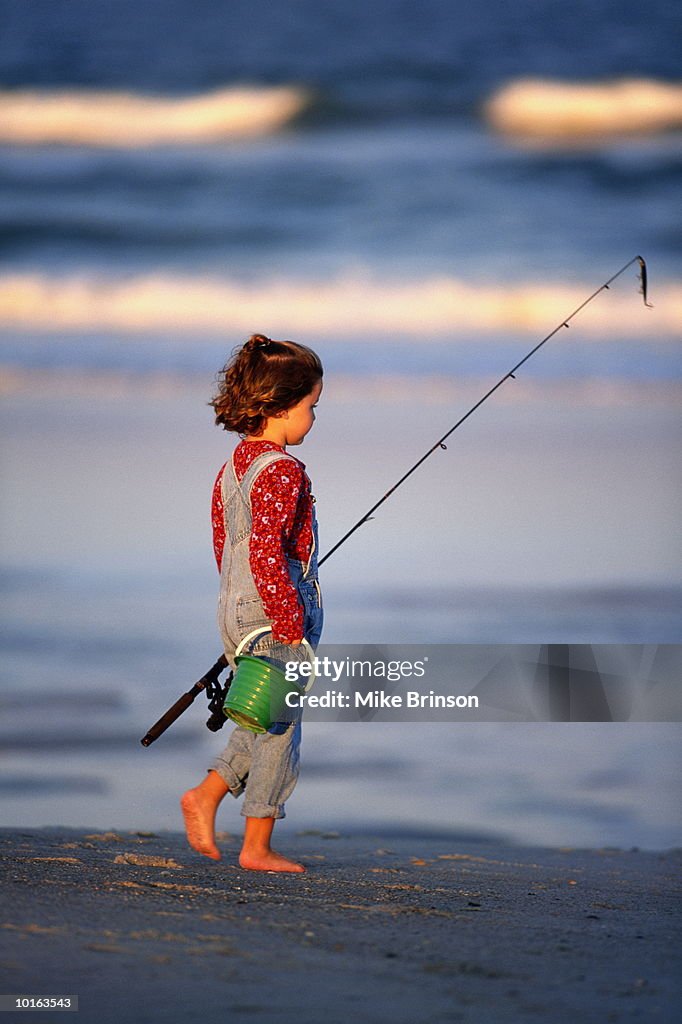 YOUNG GIRL FISHING ON BEACH, FLORIDA